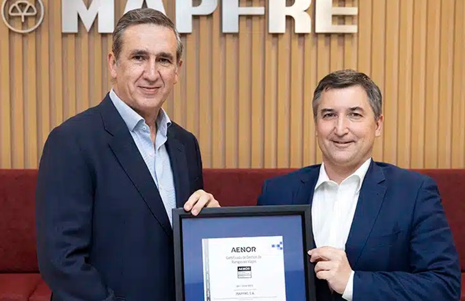 Imagen de Guillermo Llorente, director corporativo de seguridad de Mapfre, y Nicolás Henríquez, director comercial de Aenor, durante la entrega del certificado.
