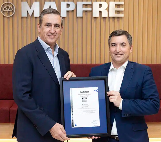 Imagen de Guillermo Llorente, director corporativo de seguridad de Mapfre, y Nicolás Henríquez, director comercial de Aenor, durante la entrega del certificado.