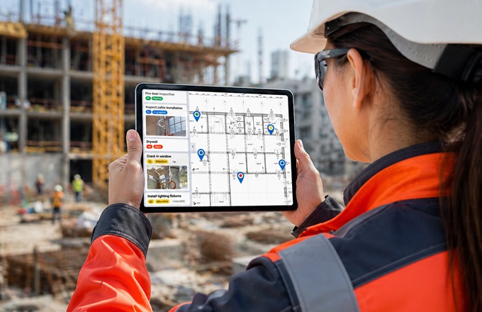 Profesional con una tableta en la construcción de un edificio